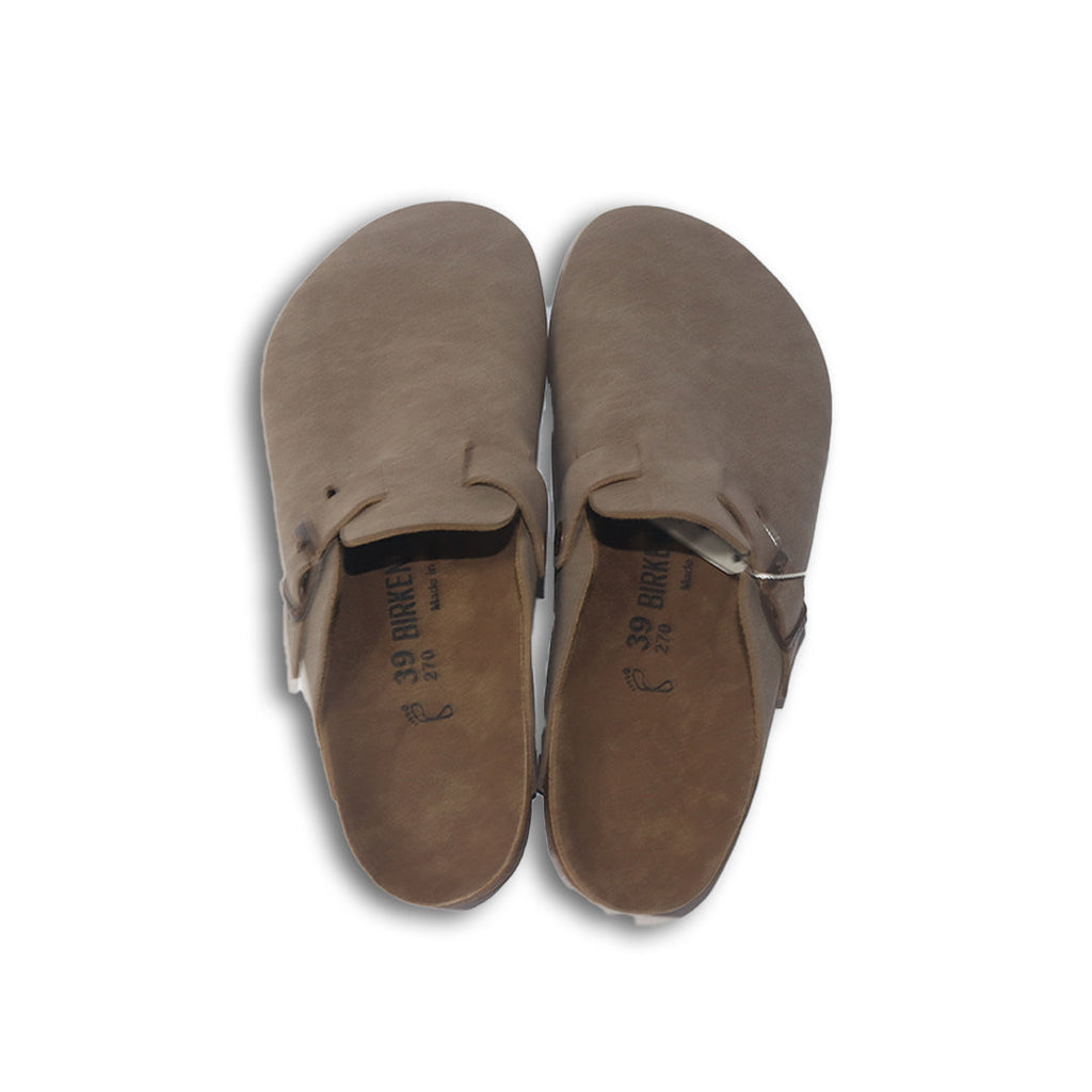 Pair of brown birkenstock slippers on a white background